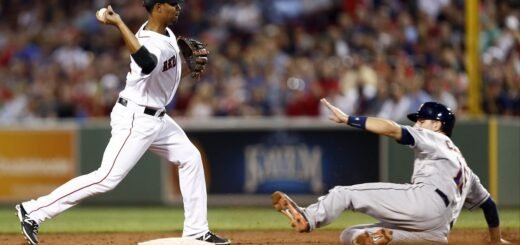 a photo of a baseball infield player about to tag the runner