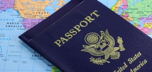 close-up photo of two American passport lying on top of a world map